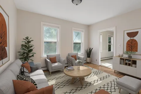 a bedroom with a large bed wooden floor and window