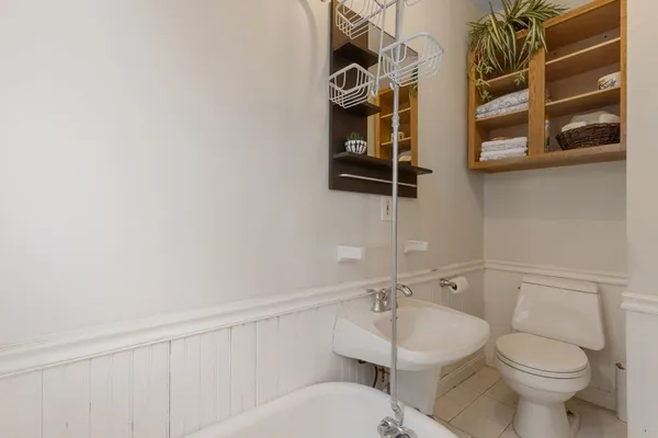 a white toilet sitting next to a bathroom sink