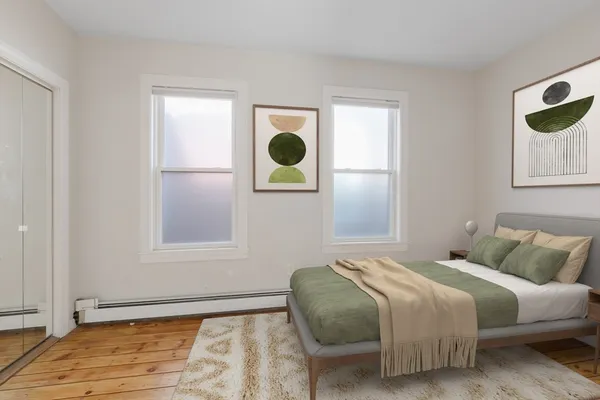 a bedroom with a bed and window