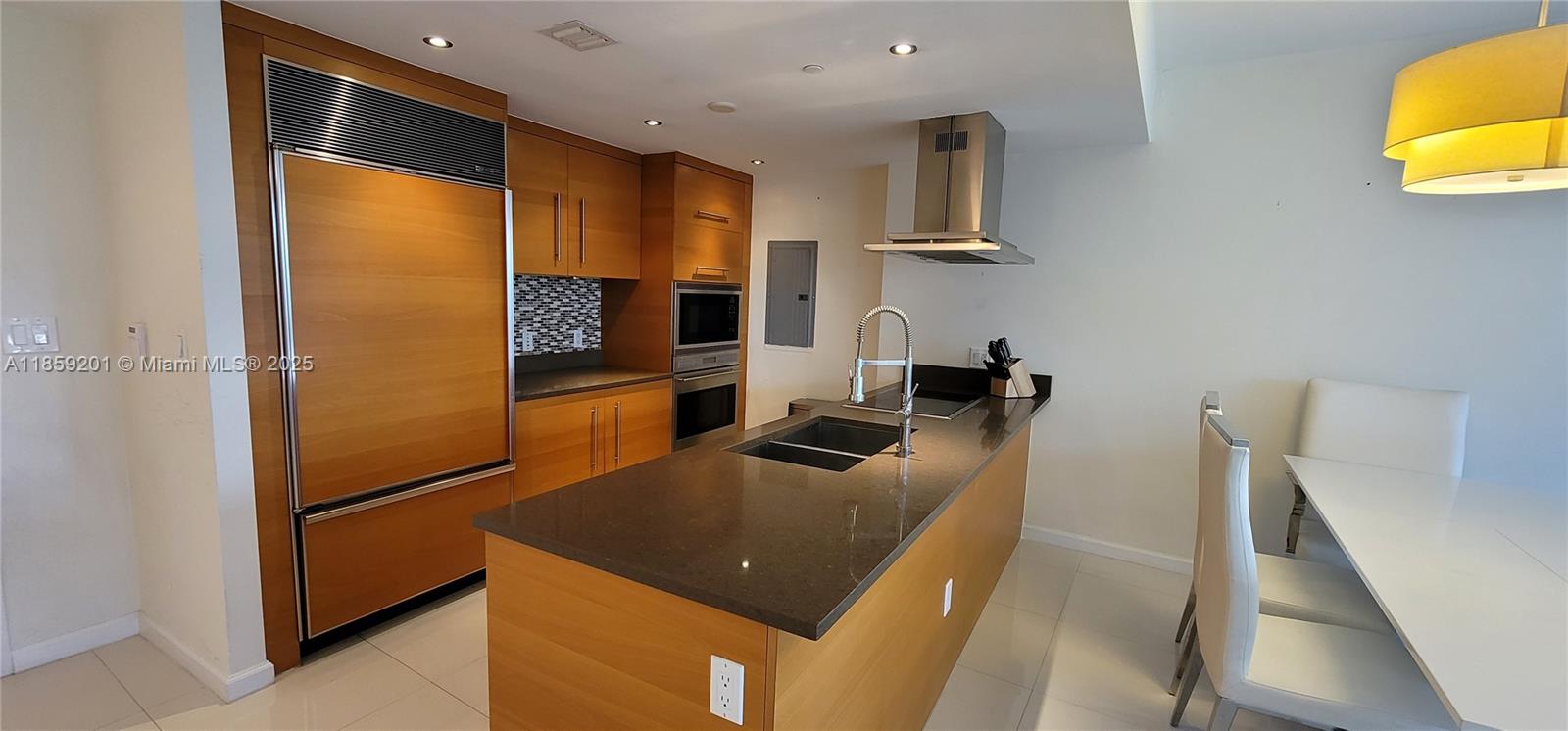 495 Brickell Avenue, Unit 420 Miami, FL 33131 - Photo 13 of 73 a kitchen with stainless steel appliances granite countertop a refrigerator a stove and a sink with wooden floor