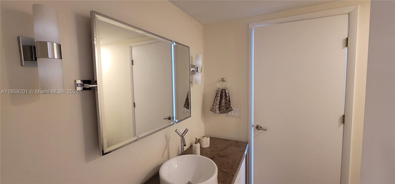 495 Brickell Avenue, Unit 420 Miami, FL 33131 - Photo 17 of 73 a bathroom with a sink and a mirror
