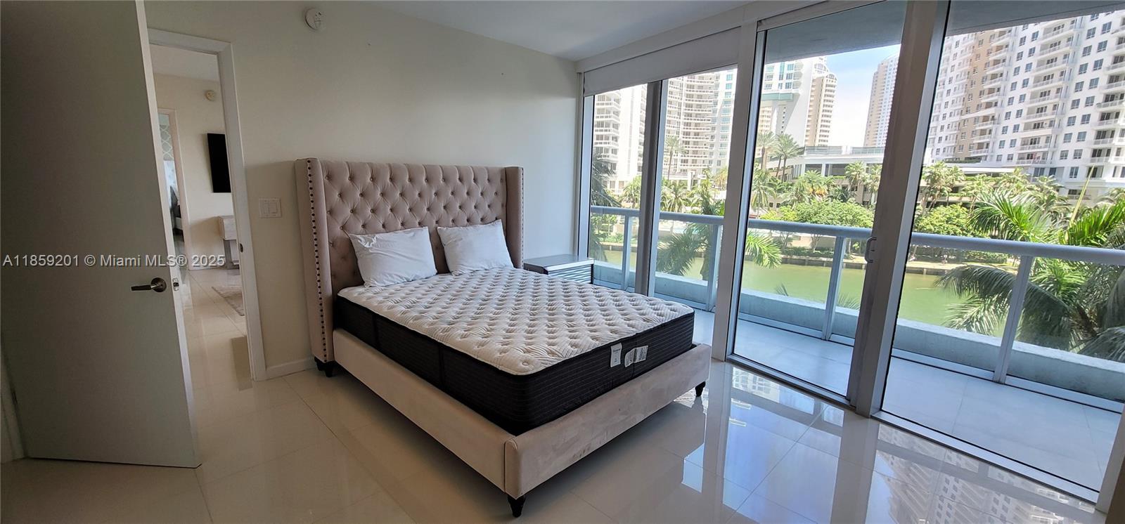 495 Brickell Avenue, Unit 420 Miami, FL 33131 - Photo 22 of 73 a bedroom with a bed and wooden floor