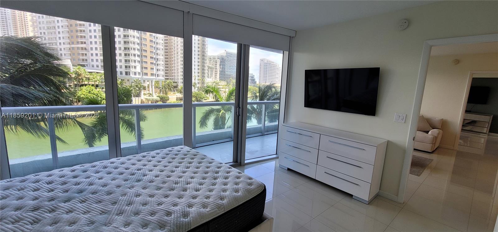 495 Brickell Avenue, Unit 420 Miami, FL 33131 - Photo 31 of 73 a bedroom with a bed and large window