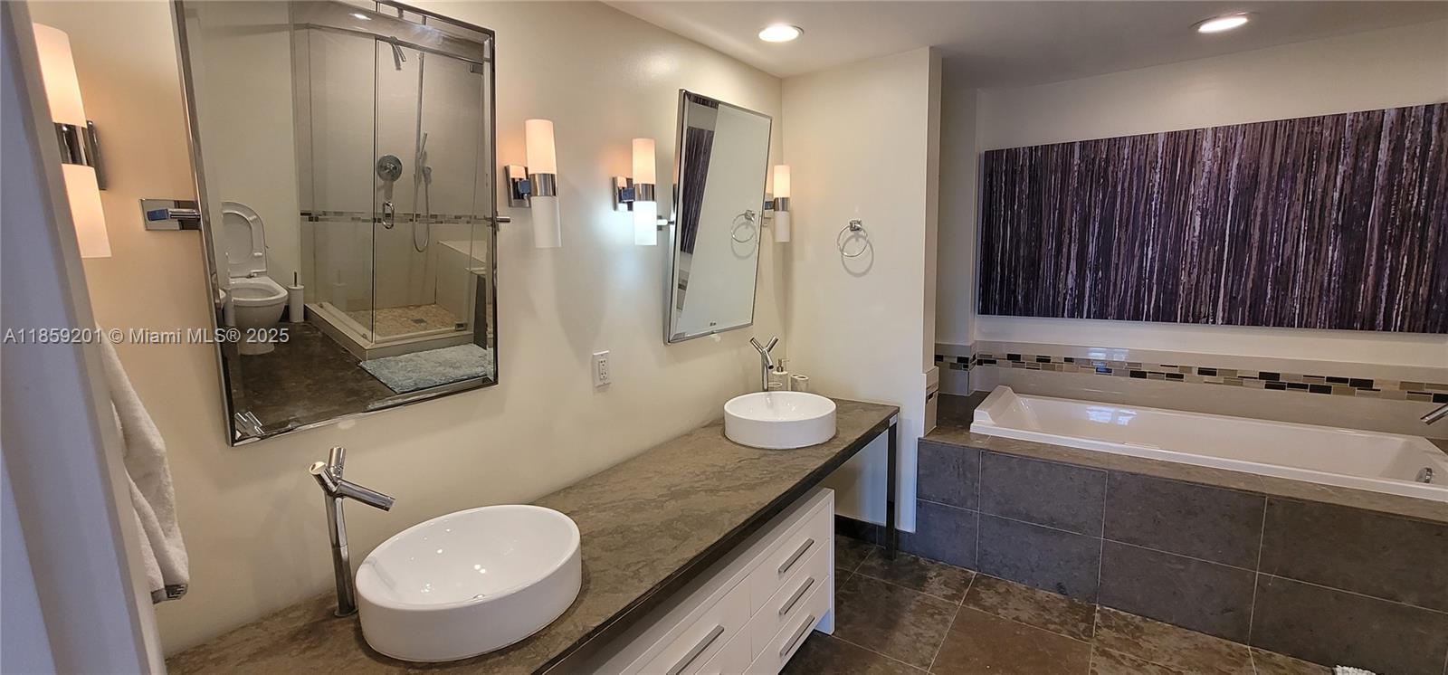 495 Brickell Avenue, Unit 420 Miami, FL 33131 - Photo 46 of 73 a bathroom with a granite countertop sink a toilet and shower