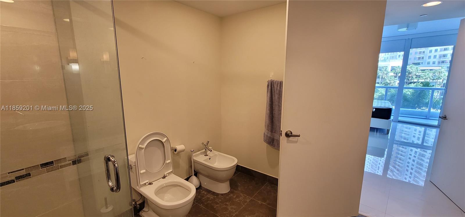495 Brickell Avenue, Unit 420 Miami, FL 33131 - Photo 49 of 73 a bathroom with a toilet a sink and shower