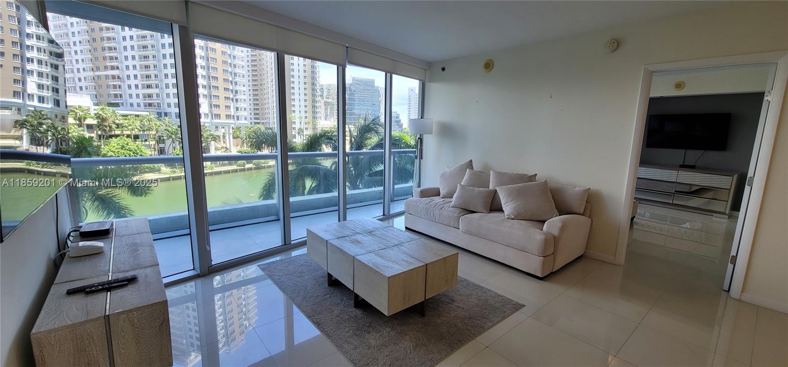 495 Brickell Avenue, Unit 420 Miami, FL 33131 - Photo 51 of 73 a living room with furniture and a floor to ceiling window