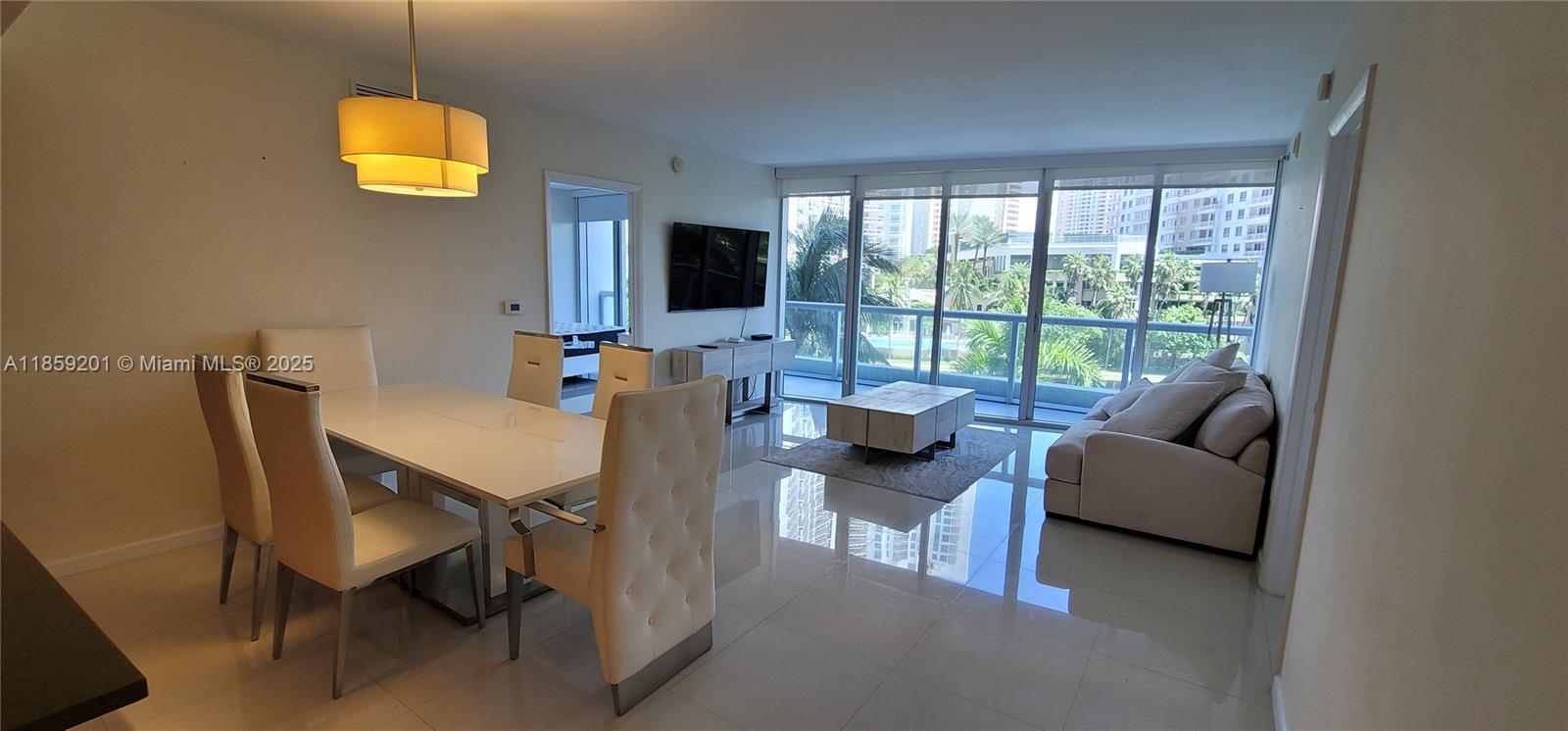 495 Brickell Avenue, Unit 420 Miami, FL 33131 - Photo 9 of 73 a living room with furniture a flat screen tv and a large window
