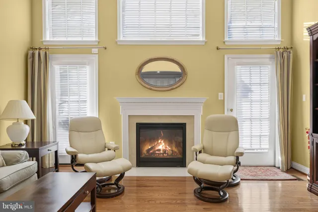 a view of a hallway with wooden floor and entryway
