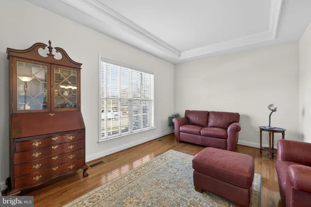 a kitchen with stainless steel appliances granite countertop a table chairs microwave and sink