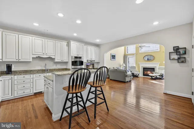 a kitchen with granite countertop white cabinets and stainless steel appliances