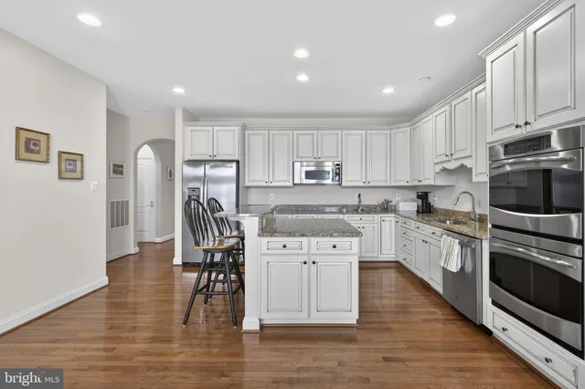 a living room with furniture a fireplace and a large window