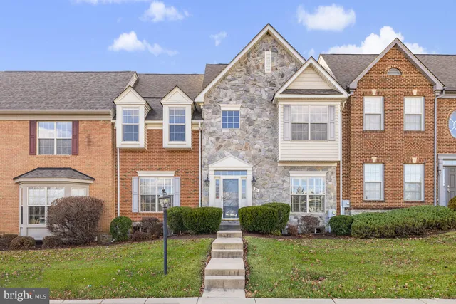 a living room with furniture a dining table and wooden floor