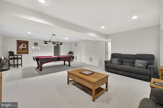 a view of a swimming pool with a yard and sitting area
