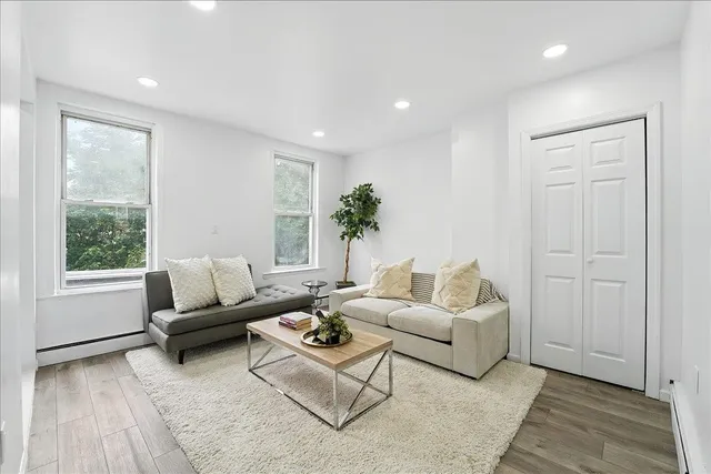 a living room with furniture and a large window