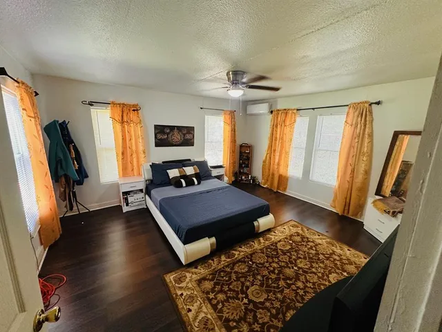 a living room with furniture flat screen tv and a large window