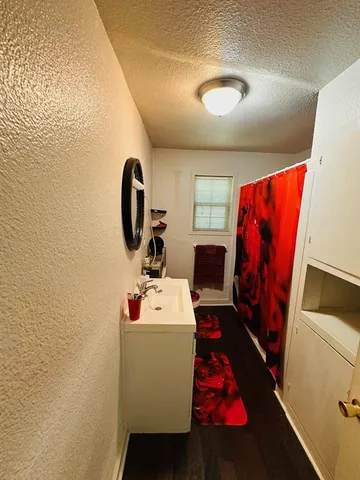 a bathroom with a sink toilet and mirror