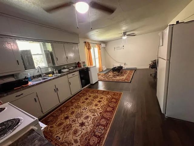 a kitchen with sink refrigerator and stove