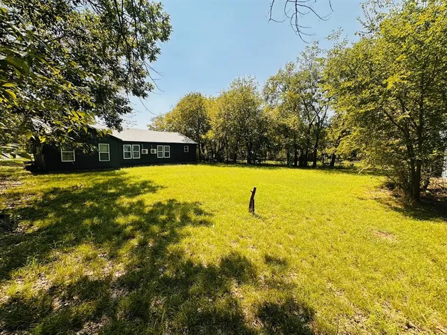 a view of yard with swimming pool and seating