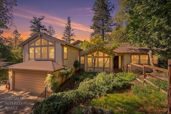 a front view of a house with a garden