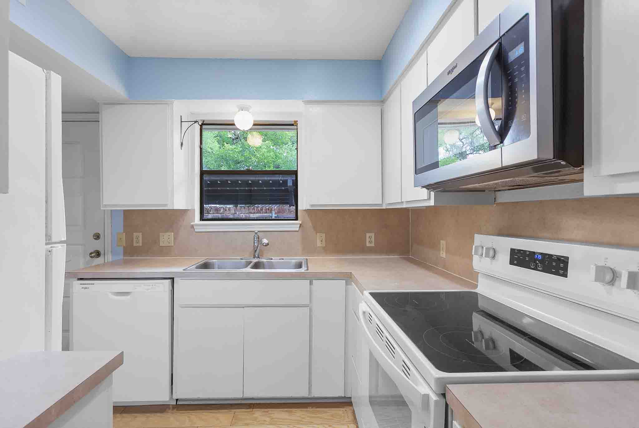 9226 Jollyville Road, Unit 132 Austin, TX 78759 - Photo 6 of 15 A well-appointed culinary space featuring essential appliances and ample countertop surfaces.
