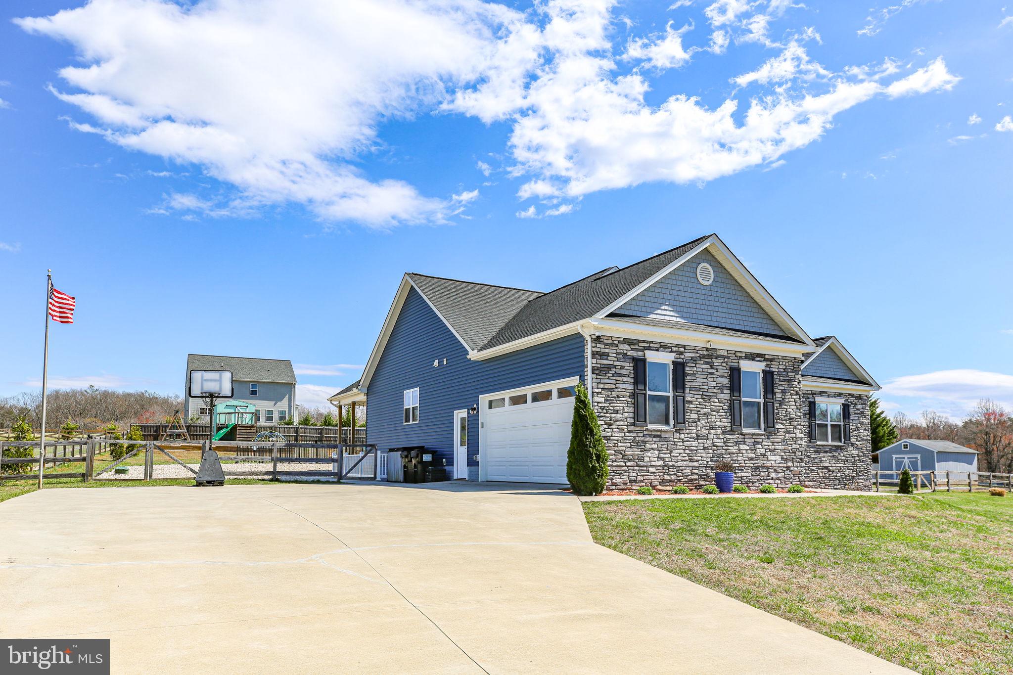 9564 Blackbird Loop Culpeper, VA 22701 - Photo 1 of 52 a front view of a house with a garden and trees