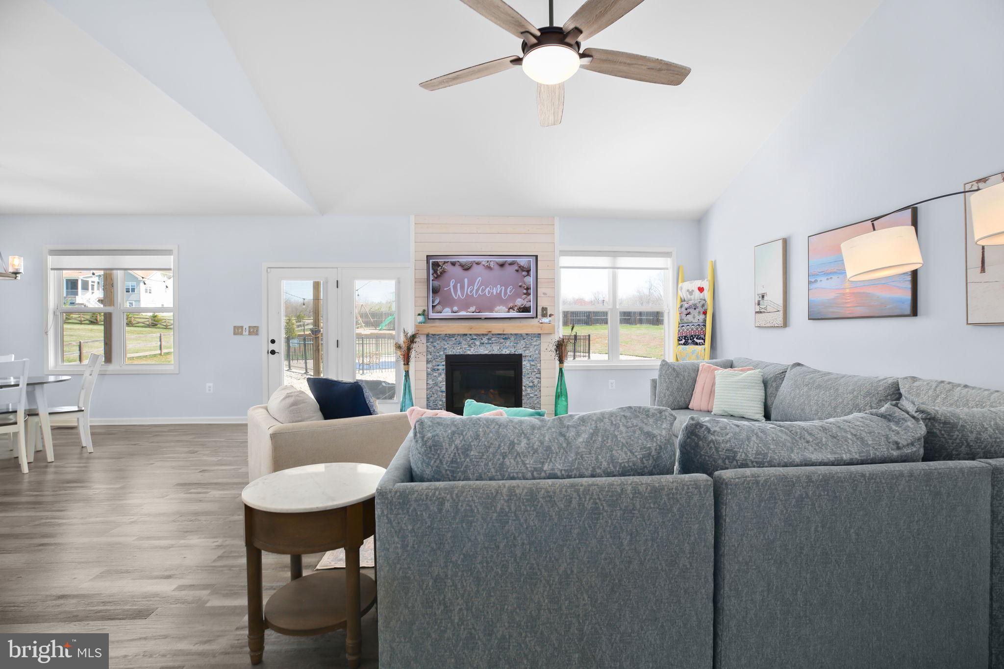 9564 Blackbird Loop Culpeper, VA 22701 - Photo 13 of 52 a living room with furniture a fireplace and a flat screen tv