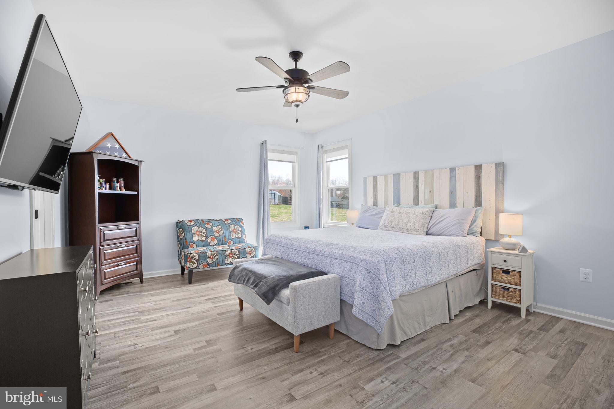 9564 Blackbird Loop Culpeper, VA 22701 - Photo 14 of 52 a spacious bedroom with a bed a couch and dresser