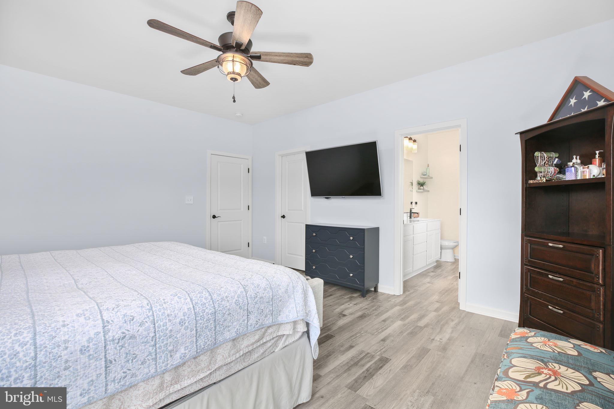 9564 Blackbird Loop Culpeper, VA 22701 - Photo 16 of 52 a bedroom with a bed and a flat screen tv