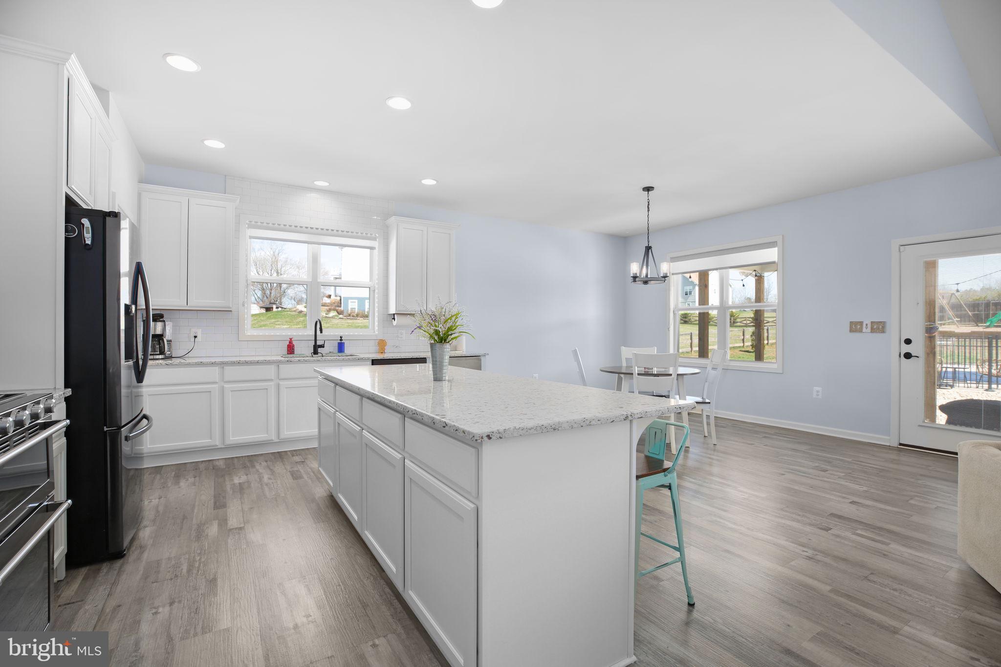 9564 Blackbird Loop Culpeper, VA 22701 - Photo 5 of 52 a kitchen with a sink appliances cabinets and wooden floor