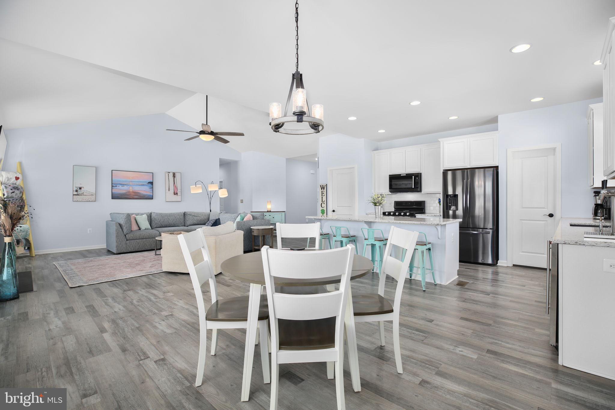 9564 Blackbird Loop Culpeper, VA 22701 - Photo 6 of 52 a view of a dining room with furniture a kitchen and chandelier