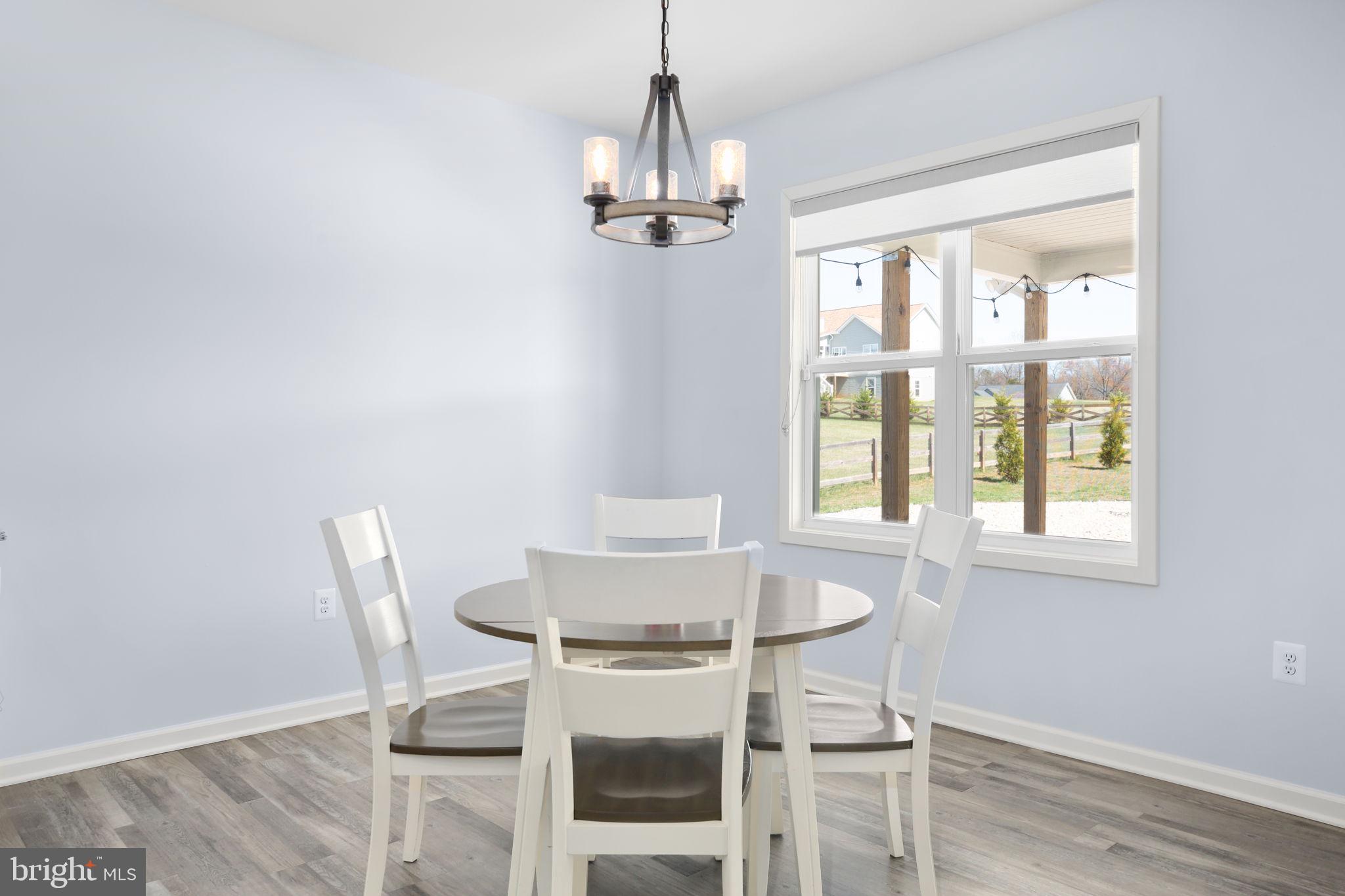 9564 Blackbird Loop Culpeper, VA 22701 - Photo 7 of 52 a dining room with wooden floor and breakfast area