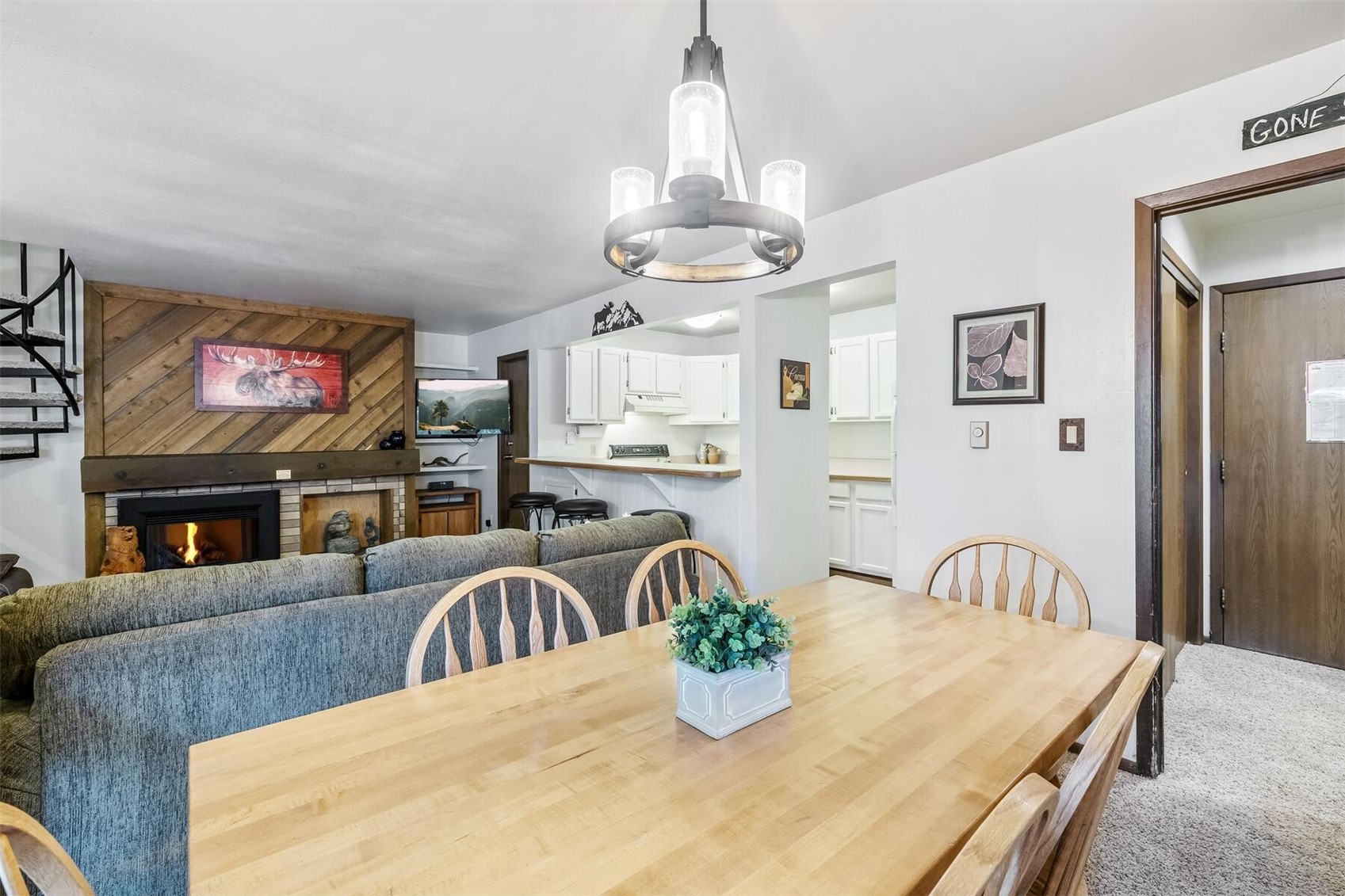100 Wild Irishman Road, Unit 1103 Keystone, CO 80435 - Photo 14 of 33 Carpeted dining room with a chandelier and wooden walls