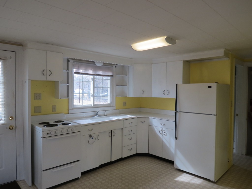 30 Harvard Road Shirley, MA 01464 - Photo 17 of 28 a kitchen with a refrigerator a sink cabinets and wooden floor