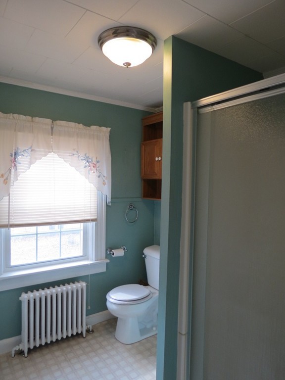 30 Harvard Road Shirley, MA 01464 - Photo 25 of 28 a bathroom with a toilet a sink and a large mirror