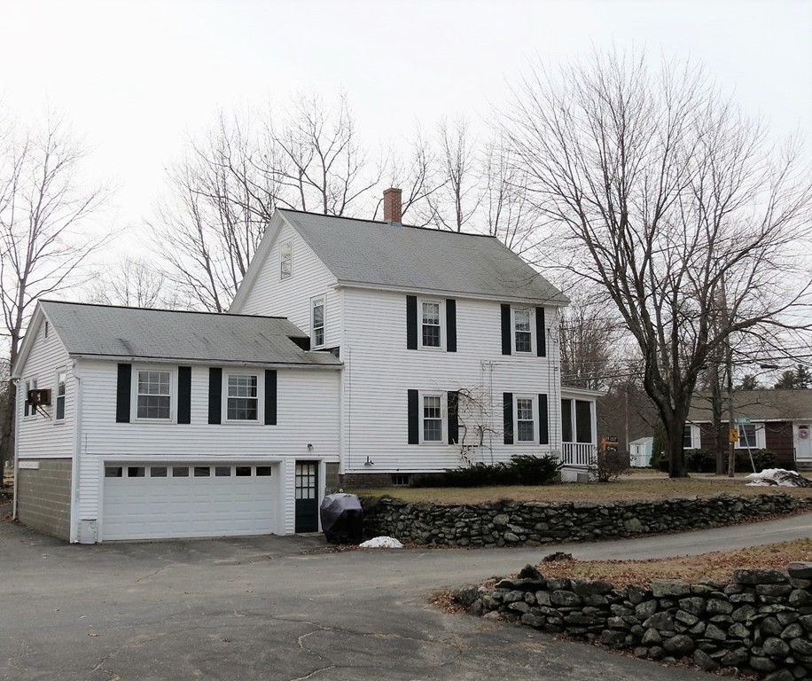 30 Harvard Road Shirley, MA 01464 - Photo 27 of 28 a view of a white house with a yard covered in snow
