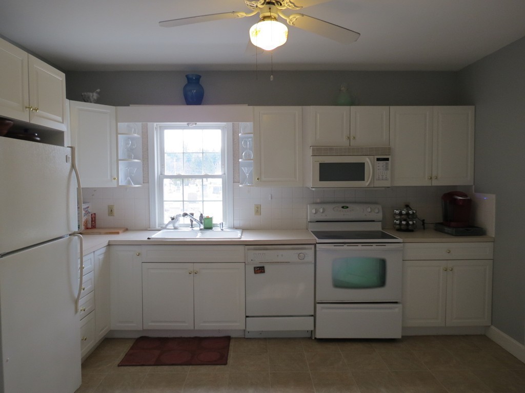30 Harvard Road Shirley, MA 01464 - Photo 7 of 28 a kitchen with a sink a stove a refrigerator and cabinets