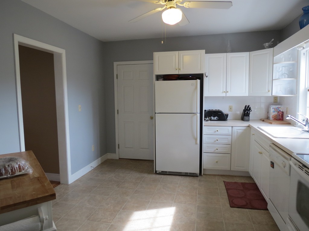 30 Harvard Road Shirley, MA 01464 - Photo 9 of 28 a kitchen with a refrigerator sink stove and cabinets