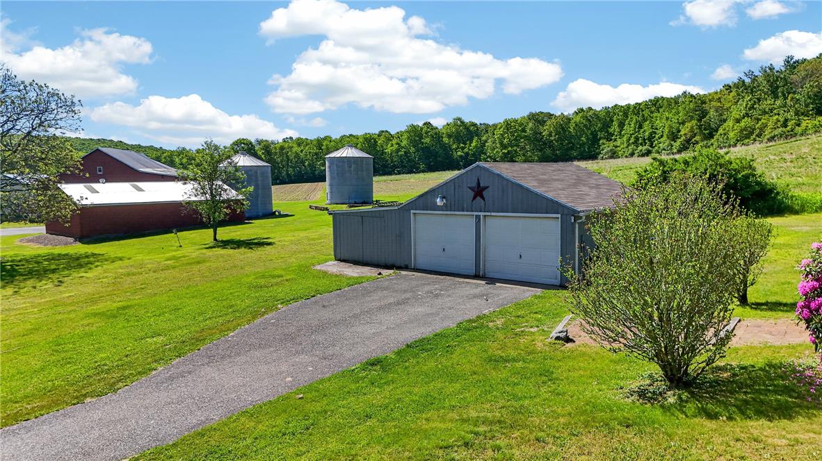 62 Stoney Road Tamaqua, PA 18252 - Photo 48 of 61 Rolling green landscape surrounds a two-car garage and red barn, offering a rural retreat.