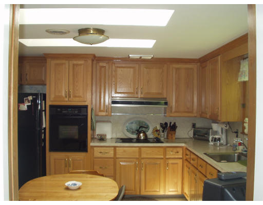 47 Jeffrey Road Wayland, MA 01778 - Photo 4 of 9 a kitchen with a sink a refrigerator and cabinets