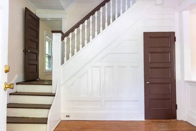 a view of staircase with white walls and windows