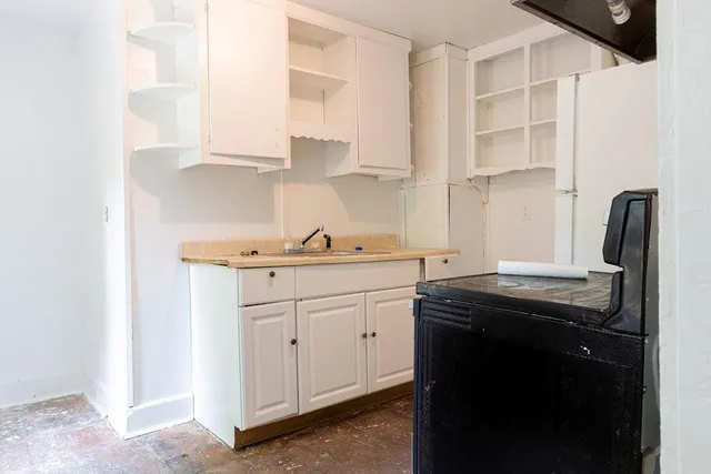 a kitchen with stainless steel appliances granite countertop a sink a stove and a refrigerator