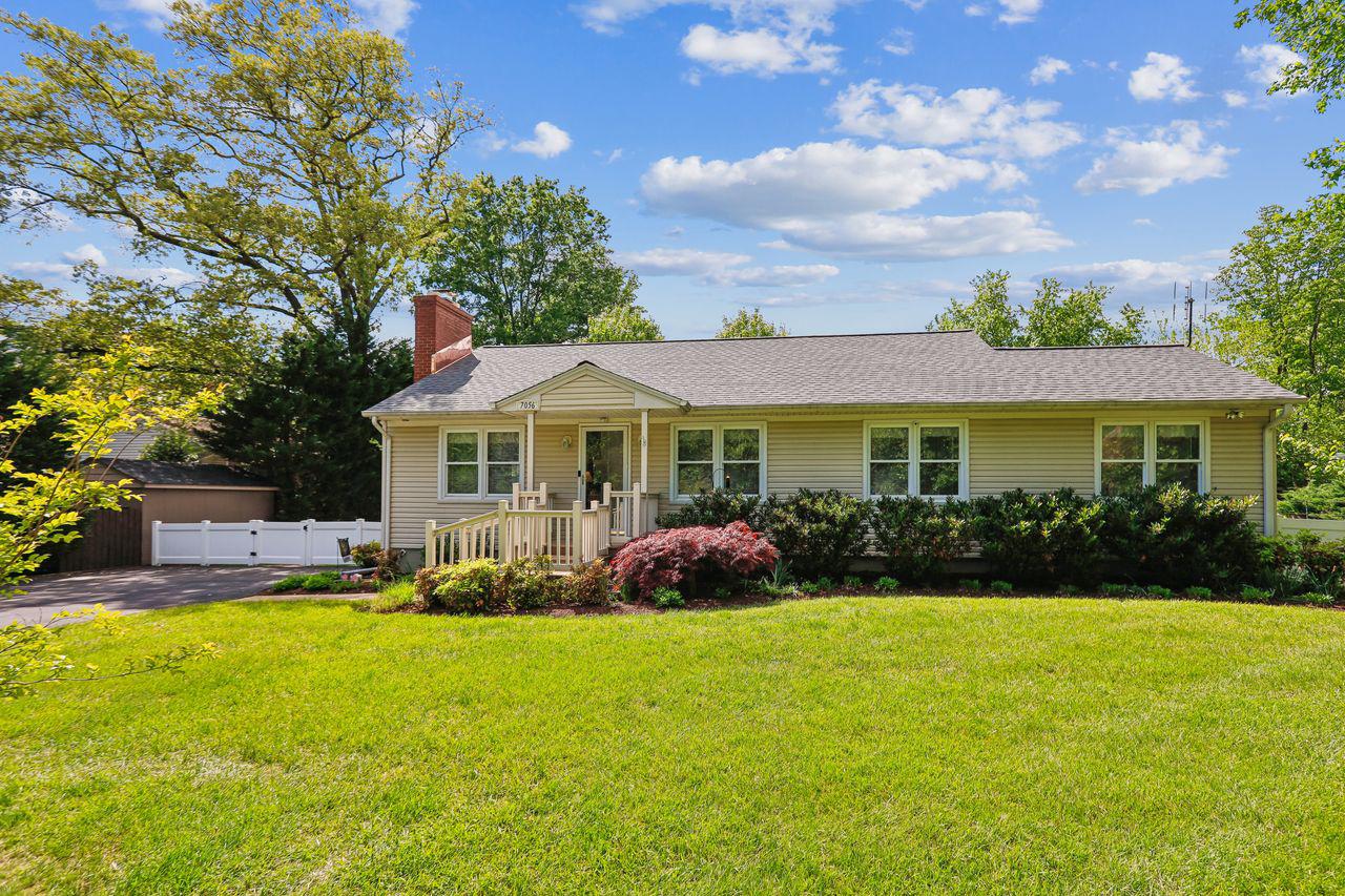 7056 Bembe Beach Road Annapolis, MD 21403 - Photo 1 of 1 a front view of a house with garden and porch