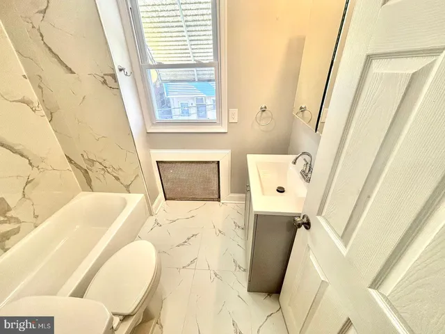 a bathroom with a sink toilet and tub