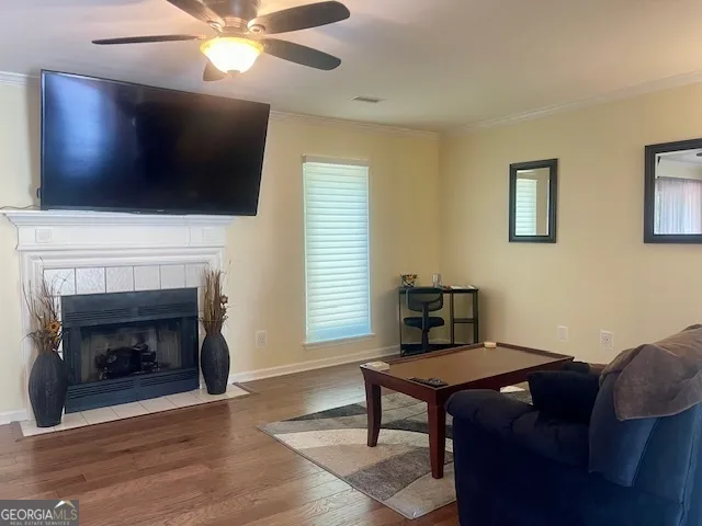 a living room with furniture a fireplace and a flat screen tv