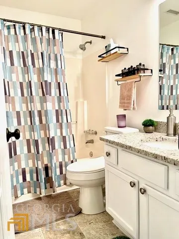 a bedroom with a bed rug and a lamp