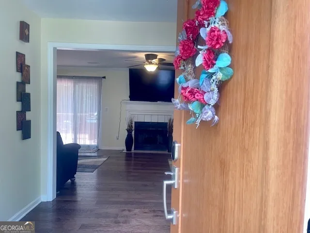 a view of a hallway with wooden floor and a window