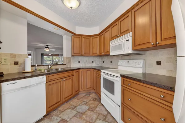 a kitchen with stainless steel appliances granite countertop a sink and cabinets