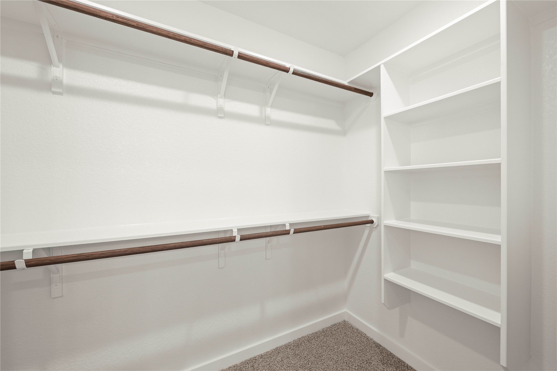 228 Gus Loop Georgetown, TX 78626 - Photo 10 of 19 Functional closet system featuring dual hanging rods and ample shelving for organized storage.