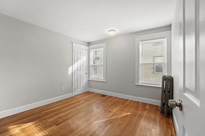 40 Ripley Road, Unit 2 Boston, MA 02121 - Photo 23 of 25 a view of empty room with wooden floor and fan