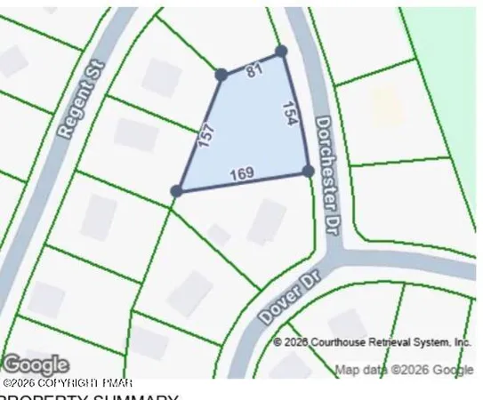 an aerial view of a swimming pool with outdoor seating